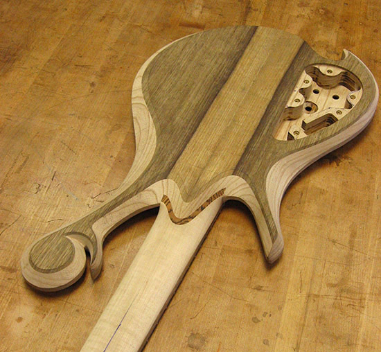 Jazz style custom bass with black limba top on back of an ash body