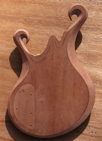 Carved mahogany core of a zebrawood custom bass