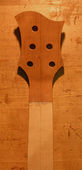 Back of a custom bass headstock with mahogany veneer