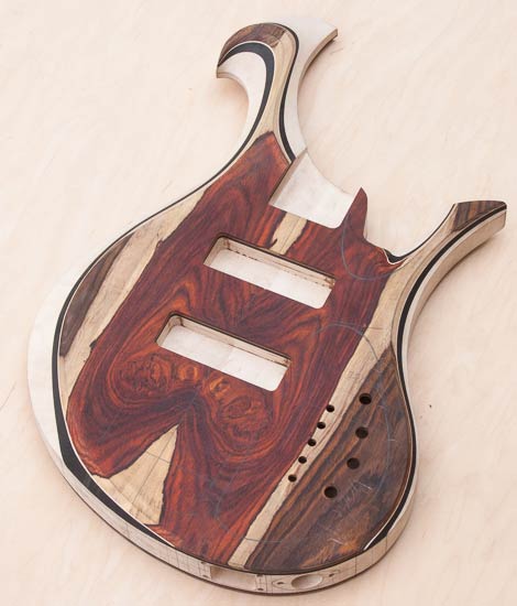 Custom bass guitar with carved Xylem-style scroll