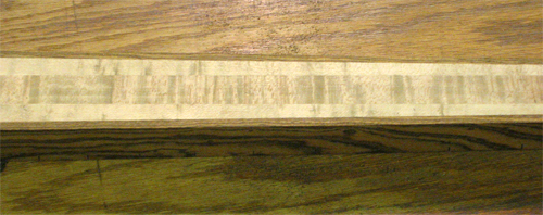 Closeup of the birdseye maple neck and bocote stringers
