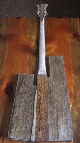 Back of the custom bass guitar with black limba sides and bocote core glued onto the neck