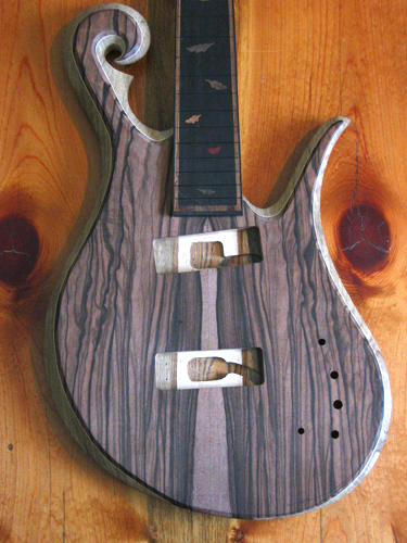 Front of the custom bass guitar after carving the body. Scroll, lower horn, fretboard and fretboard inlays are pictured.