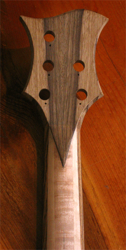 Black limba veneer of headstock back with carved neck profile of the birdseye maple and bocote neck