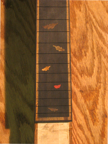Closeup of leaf inlays at fret positions 15-24 in the ebony fretboard