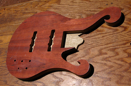 6 string bass with two scrolls and bloodwood top