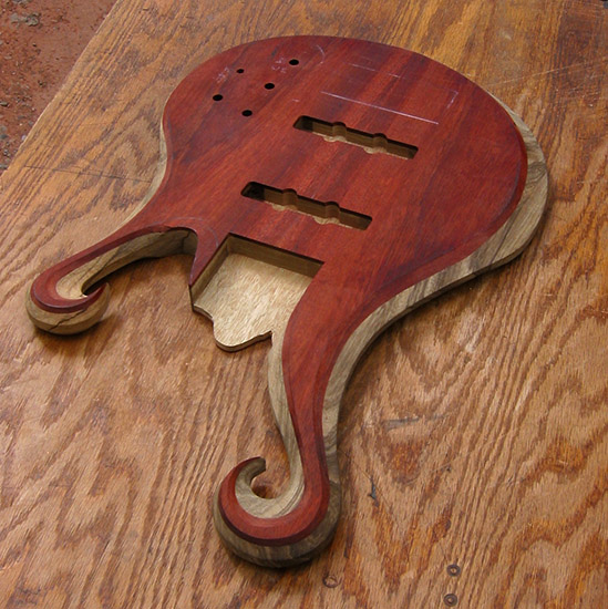 6 string bass body with carved dual scrolls