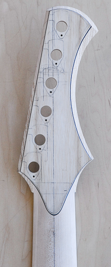 Back of a reverse-inline bass headstock with white and black outlines