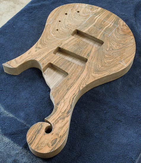 Custom bass guitar body with hook scroll, bocote tops