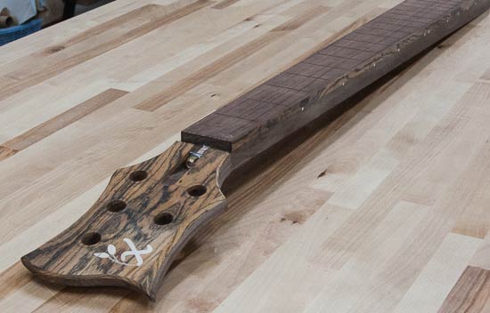 Custom bass neck with bocote headstock cap