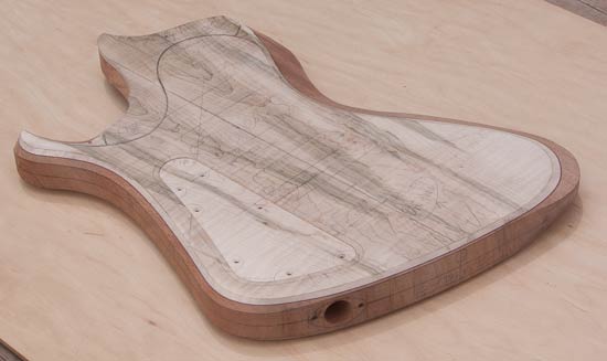 Bass guitar body with flamed maple tops, matching control cover