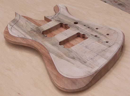 Arm contour carved into a custom bass guitar body