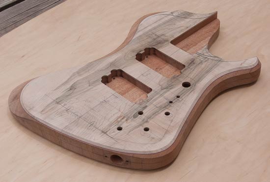 Electric bass body made of mahogany and flamed/stained maple