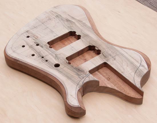 Bass guitar body with mineral-stained maple tops