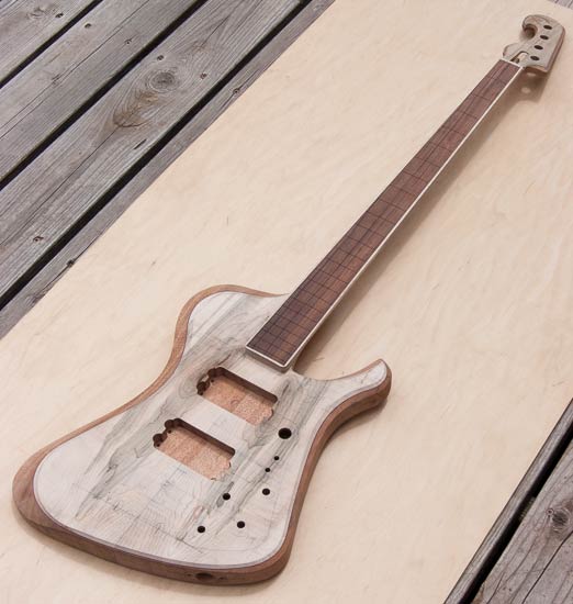 Custom electric bass with mineral-stained maple tops
