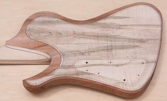 Custom bass guitar with mineral-stained maple tops, mahogany core