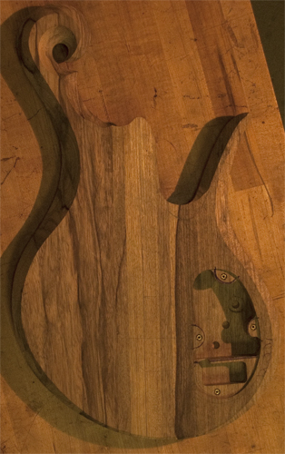 Back of a black limba bass body with carved body bevels