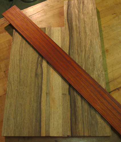 Cocobolo fretboard lying on a black limba bass body