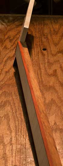 Bloodwood binding and maple fretboard of a custom bass guitar