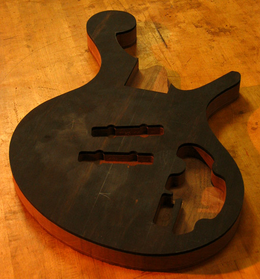 Electronics and pickup cavities on an ebony bass