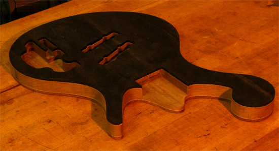 Neck pocket and scroll of an ebony and walnut bass
