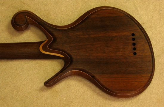 Figured maple neck heel on a Xylem 5 string bass