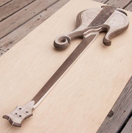 Thru-neck electric bass with exotic scroll, deep cutaway