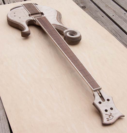 Short-scale custom bass guitar with hook scroll
