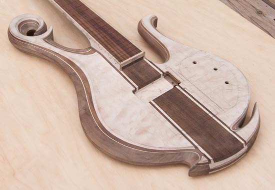 Neck-thru custom bass guitar with exotic scroll