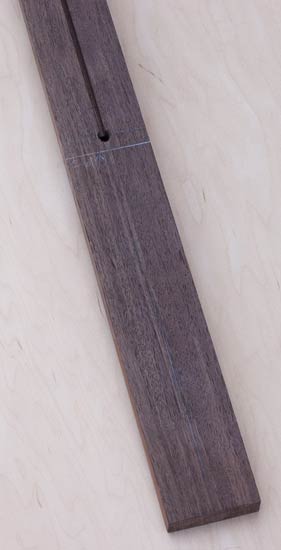 Neck blank for a neck-thru custom bass made of Peruvian walnut