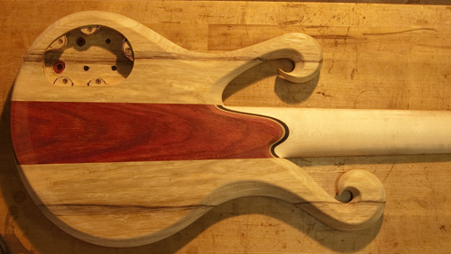 Neck heel, double scrolls and control cavity of a Xylem custom bass
