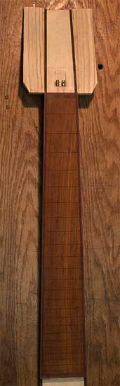 Cocobolo fretboard of a 7-string custom bass with purpleheart binding