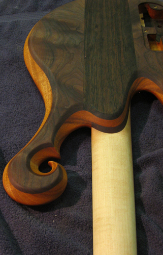 Black walnut scroll and neck joint of a Xylem custom bass guitar