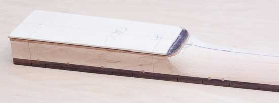 Angled neck heel of a custom bass guitar neck, rosewood accent