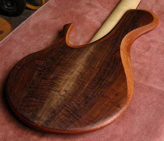 Custom single-cut bass with Claro walnut top after oil finish, back
