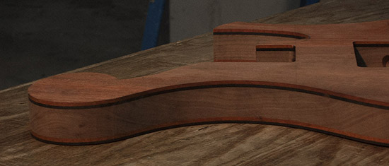 Ball scroll on a custom bass with ebony and bloodwood tops