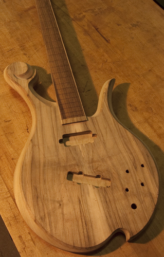 Arm bevel of a custom bass with a spalted maple top