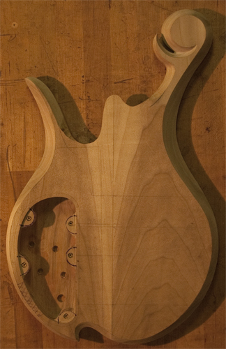 Back of a spalted maple bass body with body bevels