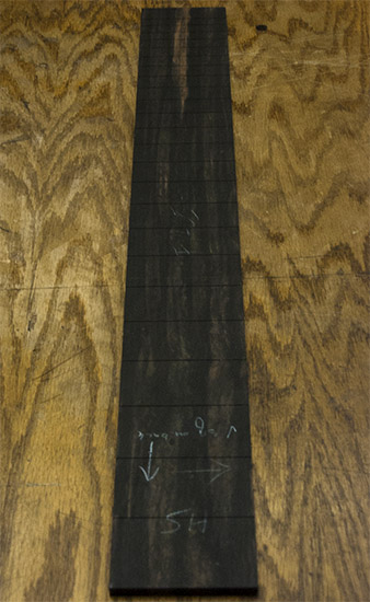 Ebony fretboard of a single-cut long-scale bass