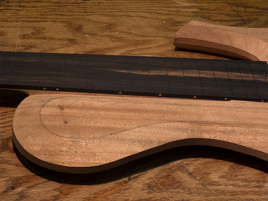 Maple fret markers on an ebony fretboard of a custom sub-contra bass