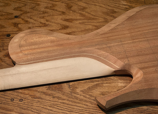 Carved neck heel of a single-cutaway bass