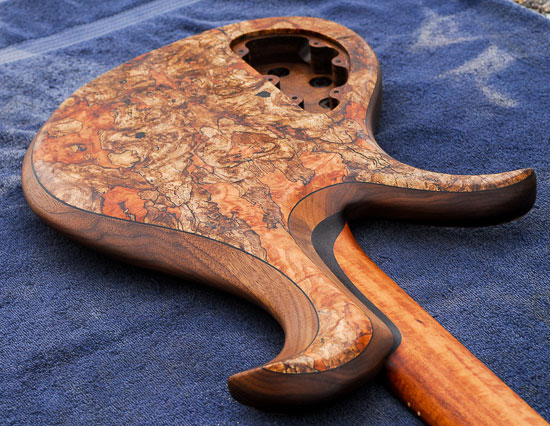Carved neck heel of a single-cut bass guitar build