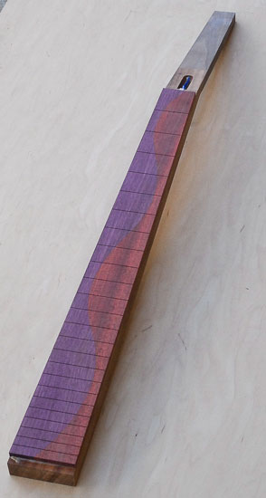 Spliced purplheart and bloodwood fretboard on a goncalo alves neck blank