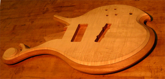 Carved arm bevel on a 5 string custom bass body