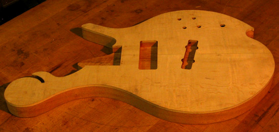 Scroll of a flamed maple Xylem bass guitar