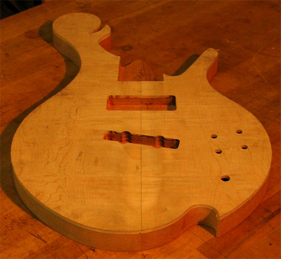 Lower bout on a flamed maple custom bass guitar