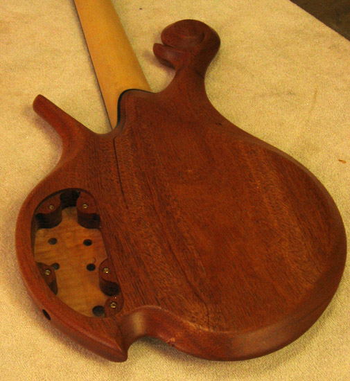 Back of a custom 5 string bass with mahogany body