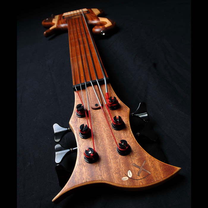 Headstock front and Xylem logo inlay of the 6 string fretless bass guitar