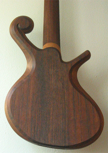 The 150 year old black walnut neck and body of the bass with the rock maple neck shim