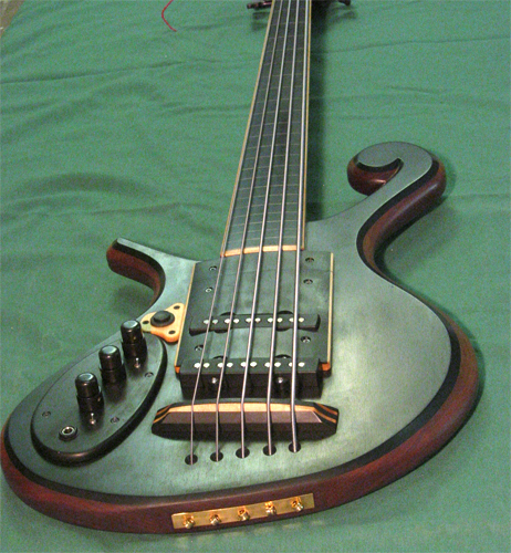 The ebony custom bass guitar after completion with the bass' killswitch and radius ramp installed